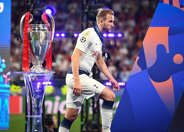 Harry Kane walks up to receive his winners' medal last season.